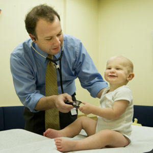 Greg Rice, MD with patient in clinic