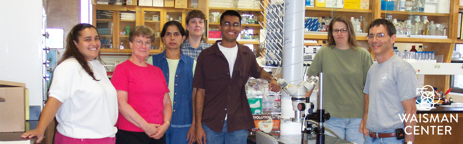 Albee Messing (left) and Tracy Hagemann (next to Messing) stand in Messing’s lab with other lab members in 2001