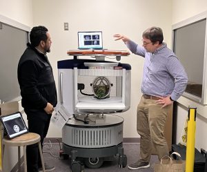 Doug Dean, PhD and José Guerrero, PhD giving a demonstration on the use of the portable MRI scanner.