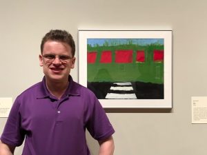 Billy Borg, standing in front of his piece titled "Road" at the Chazen in 2018.